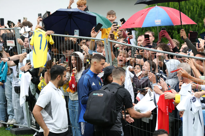 Cristiano Ronaldo ký tặng người hâm mộ bên ngoài khách sạn Gut Brandlhof. Ảnh: Bild