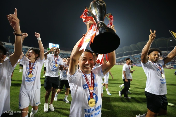 HLV Vũ Hồng Việt nâng cup vô địch V-League 2024-2025, sau trận Nam Định thắng Hà Tĩnh 1-0 ở vòng 26, trên sân Thiên Trường, Nam Định ngày 22/6/2025. Ảnh: Hiếu Lương