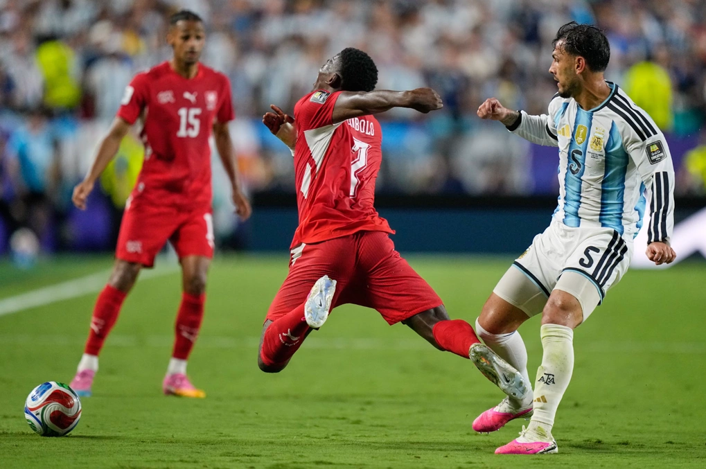 Luật VAR mới, thẻ đỏ cũ: Embolo ra sân — Leandro Paredes (phải) va chạm với Breel Embolo...