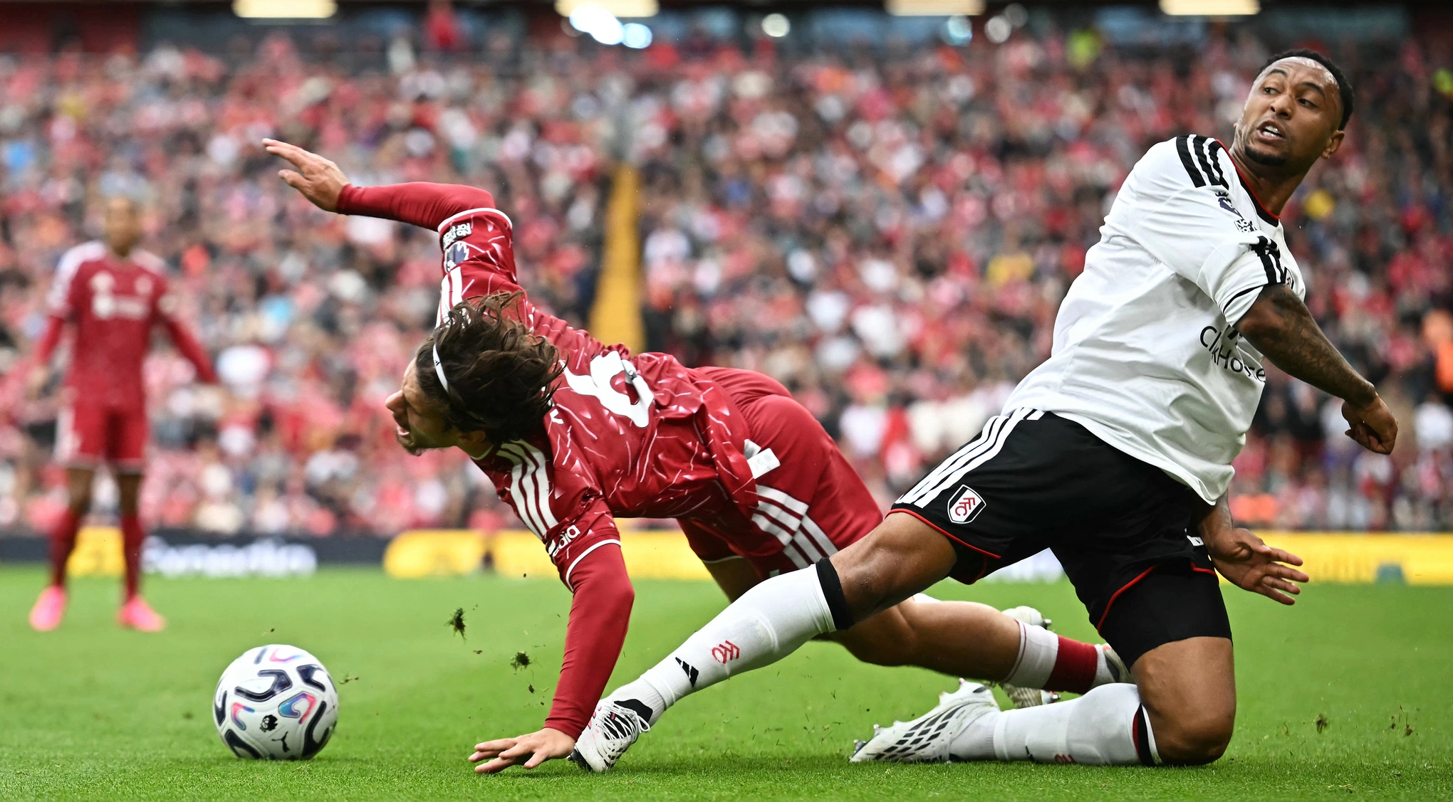 Hậu vệ Milos Kerkez (trái) của Liverpool tranh bóng với hậu vệ Kenny Tete của Fulham trong trận đấu tại Ngoại hạng Anh trên sân Anfield, Liverpool, Anh, ngày 12/9/2026. Ảnh: AFP